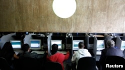 Computer users are pictured at an internet cafe in Sao Paulo, Brazil, March 3, 2011.