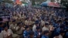 Indian Central Reserve Police Force (CRPF) soldiers hold candles and pay tribute to their colleagues killed in Thursday's attack on a paramilitary convoy in Kashmir, in Hyderabad, India, Friday, Feb. 15, 2019. 