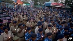 Indian Central Reserve Police Force (CRPF) soldiers hold candles and pay tribute to their colleagues killed in Thursday's attack on a paramilitary convoy in Kashmir, in Hyderabad, India, Friday, Feb. 15, 2019. 