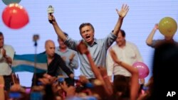Opposition presidential candidate Mauricio Macri celebrates his victory with supporters at his campaign headquarters in Buenos Aires, Argentina, Nov. 22, 2015