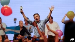Opposition presidential candidate Mauricio Macri celebrates his victory with supporters at his campaign headquarters in Buenos Aires, Argentina, Nov. 22, 2015