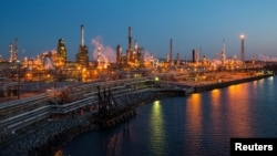 FILE - The Philadelphia Energy Solutions oil refinery owned by The Carlyle Group is seen at sunset in Philadelphia, March 26, 2014. The refinery's bankruptcy has prompted a new look at biofuels policy.