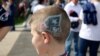 A young New England Patriots fan sports his team's logo painted in his hair at the Super Bowl in Houston, Texas. (B. Allen/VOA)
