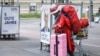 A homeless woman walks by damaged election campaign posters reading '5 Good Years' of the Freedom Party of Austria (FPOe) in Vienna, Austria, on Sept. 28, 2024. General elections in Austria will take place on Sept. 29, 2024. 