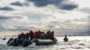 FILE — Migrants board a smuggler's boat in an attempt to cross the English Channel, on April 26, 2024. 