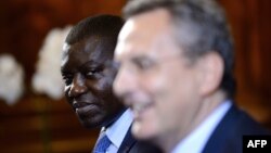 Republic of Central Africa Foreign Minister Charles Armel Doubane (L) looks on as Sant'Egidio organization president Marco Impagliazzo addresses a political delegation from Central African Republic, June 19, 2017, inside the Sant'Egidio community church in Rome.