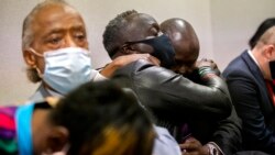 Ahmaud Arbery's father, Marcus Arbery, center, his hugged by his attorney, Benjamin Crump, after the jury convicted Travis McMichael in the Glynn County Courthouse, Nov. 24, 2021, in Brunswick, Ga.