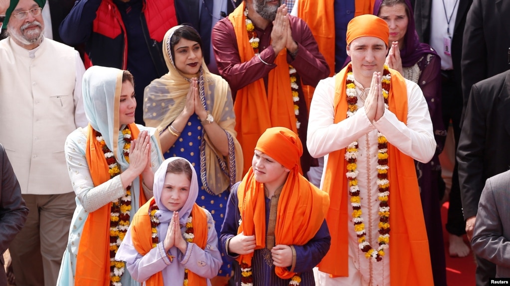 Canadian Prime Minister Justin Trudeau with his wife Sophie Gregoire, daughter Ella Grace and son Xavier, greet the people during their visit to the holy Sikh shrine of Golden temple in Amritsar, India Feb. 21, 2018.