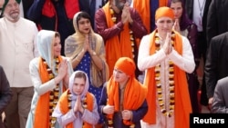 Canadian Prime Minister Justin Trudeau with his wife Sophie Gregoire, daughter Ella Grace and son Xavier, greet the people during their visit to the holy Sikh shrine of Golden temple in Amritsar, India Feb. 21, 2018. 