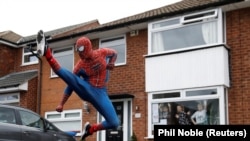 Jason Baird is seen dressed as Spiderman during his daily exercise to cheer up local children in Stockport, Britain, April 1, 2020