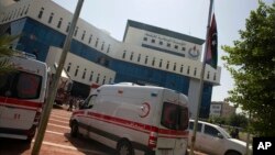 Ambulances and firefighters gather at the headquarters of the national oil company after an attack by gunmen in Tripoli, Libya, Sept. 10, 2018. 
