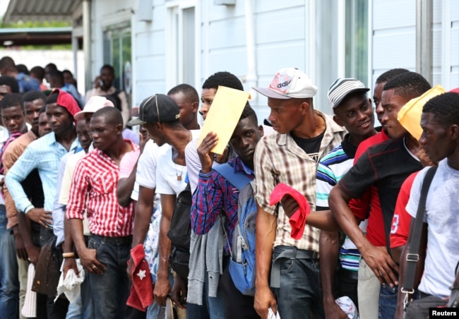 Haitians stand in line as they try to join the country's reformed military in Gressier, Haiti, July 18, 2017.