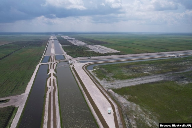 Canals run past the site, top right, where sugar cane fields are being converted into the Everglades Agricultural Area Reservoir, Wednesday, May 15, 2024, in South Bay, Fla.