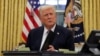 President Donald Trump signs documents as he issues executive orders and pardons for Jan. 6 defendants in the Oval Office at the White House on Inauguration Day in Washington, Jan. 20, 2025. 