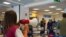 Passengers arriving in Rome from four Mediterranean countries receive instructions by airport staff, right, as they line up with their suitcases at Rome's Leonardo da Vinci airport to be immediately tested for COVID-19, Aug.16, 2020. 