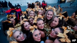 Revellers stay warm before the 92nd annual Macy's Thanksgiving Day Parade in New York, Nov. 22, 2018. 