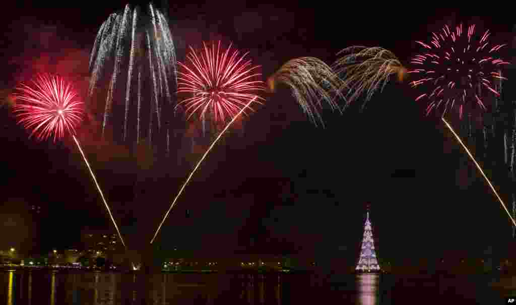 Fireworks explode over the floating Christmas tree at the Rodrigo de Freitas Lagoon as it is lit for the Christmas season in Rio de Janeiro, Brazil, Dec. 12, 2015.