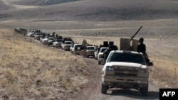 FILE - Fighters led by the al-Qaida-linked al-Nusra Front gather on the Syrian side of the Qalamun hills close to the Lebanese border, Sept. 22, 2014.