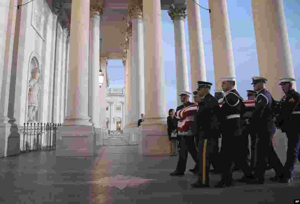 A military honor guard carries the casket of former President George H. W. Bush into the Capitol, Dec. 3, 2018 in Washington. 