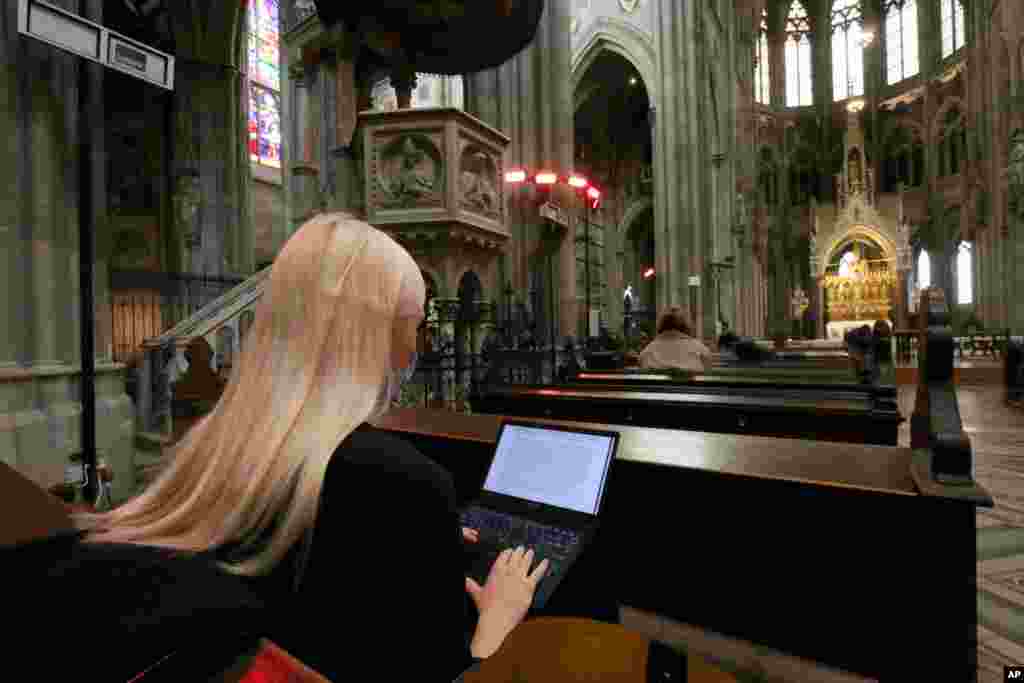 Students attend lectures via a video stream shown in the neo-gothic church &#39;Votivkirche&#39; in Vienna, Austria. Due to the coronavirus pandemic, the church was converted into an auditorium for the university of Vienna. 
