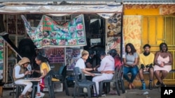 Customers have their nails done in Soweto, South Africa, Sept. 16, 2020.