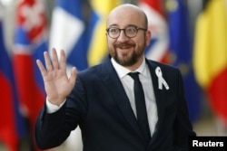 Belgium’s Prime Minister Charles Michel waves as he arrives at a European Union leaders summit in Brussels, Belgium, March 22, 2018.