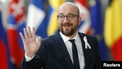 Belgium’s Prime Minister Charles Michel waves as he arrives at a European Union leaders summit in Brussels, Belgium, March 22, 2018.