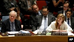 United Kingdom U.N. Ambassador Mark Lyall Grant, left, listens as Samantha Power, the U.S. ambassador to the United Nations, speaks during a meeting of the U.N. Security Council, Dec. 22, 2014