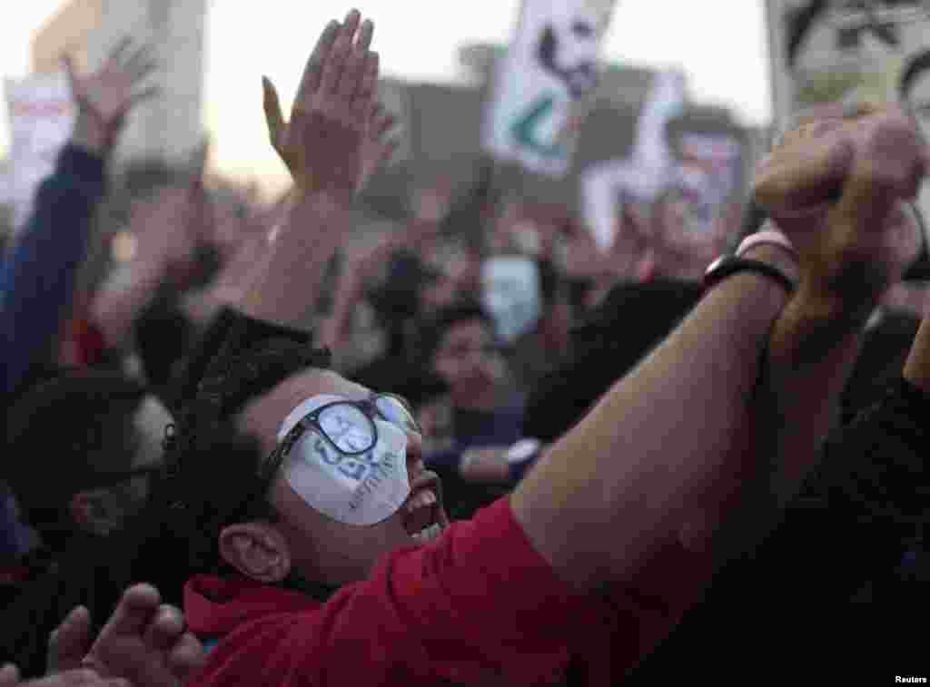 An activist, who lost an eye during clashes with police in November 2011, chants slogans as he joins soccer fans during a protest in Cairo. Hundreds gathered to demand justice for 74 people killed in a stadium stampede last year, as a court prepared to issue a verdict in the case.