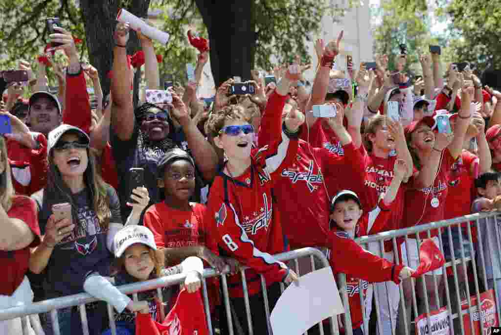 Fans react to seeing members of the Washington Capitals hockey team during the Stanley Cup victory parade route along the National Mall in Washington.