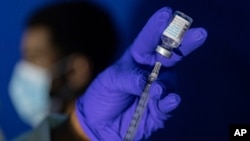 (FILE) Family nurse practitioner Carol Ramsubhag-Carela prepares a syringe with the Mpox vaccine before inoculating a patient at a vaccinations site on Aug. 30, 2022.