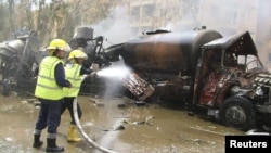 Syrian firefighters work at the site of an explosion in Deir el-Zour, in this handout released by Syria's national news agency SANA, May 19, 2012.