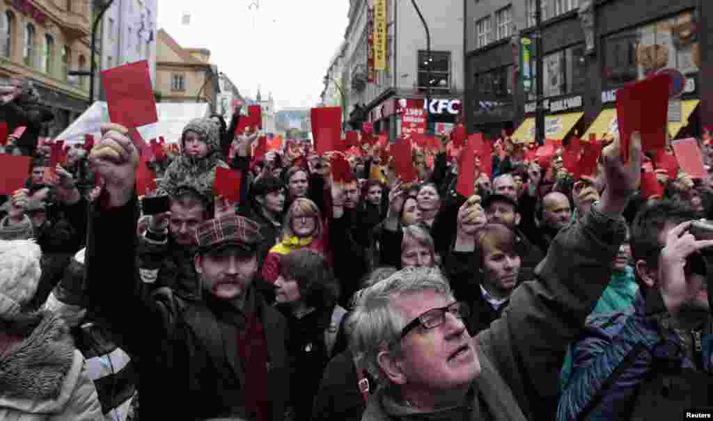 Demonstrators show symbolic red cards to Czech President Milos Zeman during a protest rally in Prague, Czech Republic.