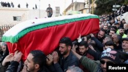 FILE —Mourners carry the coffin of Farah Omar, Lebanon-based Al Mayadeen TV channel correspondent, who was killed along with Al Mayadeen cameraman Rabih al-Maamari by what their channel said was an Israeli strike in southern Lebanon, in Mashghara, Lebanon, November 22, 2023.