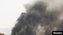 Smoke billows from the site of Saudi-led air strikes in Sanaa, Yemen, March 7, 2021.
