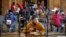 FILE - In this March 31, 2021, file photo, freshman Hugo Bautista eats lunch separated from classmates by plastic dividers at Wyandotte County High School in Kansas City, Kan., on the first day of in-person learning. (AP Photo/Charlie Riedel, File)
