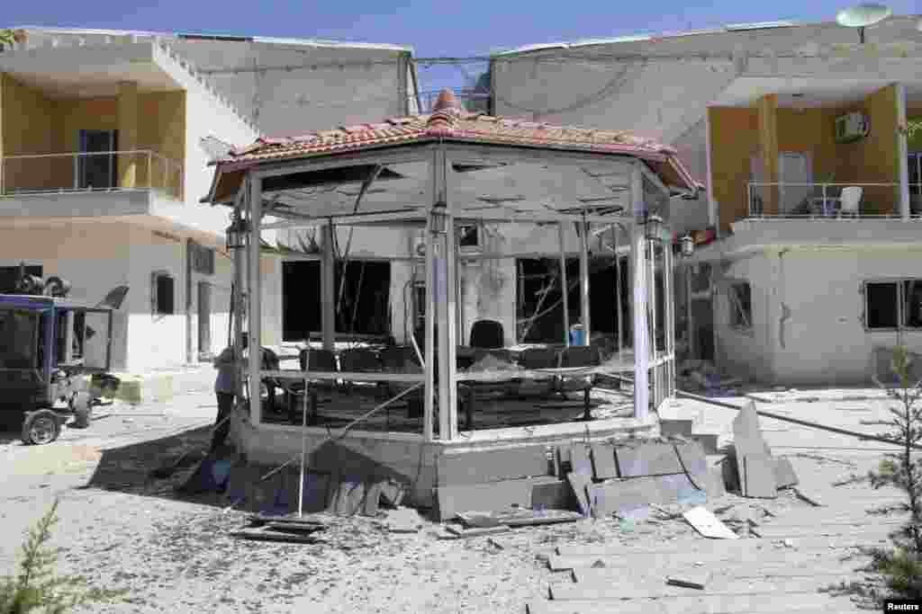 Damaged buildings after gunmen stormed the headquarters of al-Ikbariya