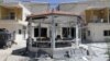 Damaged buildings are seen after gunmen stormed the headquarters of al-Ikbariya news channel near Damascus, Syria, June 27, 2012. 