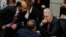 Former President Alvaro Uribe, right, talks to Senator of the Democratic Center Alfredo Rangel during a Senate session in Bogota, Colombia, Monday, Oct. 3, 2016. Colombians rejected a peace deal with leftist rebels in a national referendum Sunday. Uribe led the opposition.