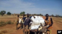 Farmers in Burkina Faso haul their harvest stored in airtight bags.