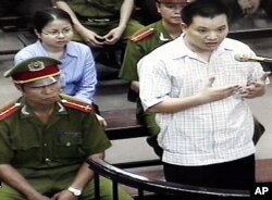 FILE - Nguyen Van Dai, right, testifies in this May 2013 file photo, originally taken from TV footage. The well-known Vietnamese human rights lawyer was arrested Wednesday on anti-state "propaganda" charges.