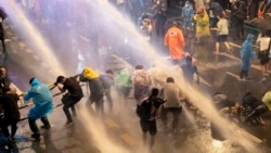 Pro democracy demonstrators face water canons as police try to disperse them from their protest venue in Bangkok, Thailand, Friday, Oct. 16, 2020. Thailand prime minister has rejected calls for his resignation as his government steps up efforts to stop st
