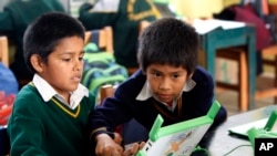 FILE - Students use a laptop at a school in a shantytown on the outskirts of Lima, Peru, June 8, 2012. Peru has sent more than 800,000 laptop computers children across the country, in an effort to leverage digital technology in the fight against poverty.