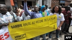 Protesters gather outside the Gambian embassy in Senegal to demand President Yahya Jammeh halt the mass execution of prisoners, August 30, 2012.