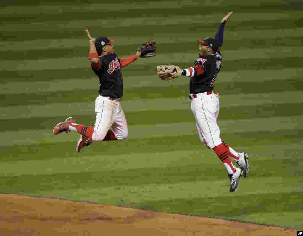 Cleveland Indians' Francisco Lindor and Rajai Davis celebrate after winning Game 1 of the Major League Baseball World Series against the Chicago Cubs, in Cleveland, Ohio, Oct. 25, 2016.