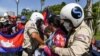 FILE - Local security personnel guards confiscate a loudspeaker from a protester during a protest to mark the 29th annniversary of the Paris Peace Accord in front of the US embassy in Phnom Penh on October 23, 2020. (AFP)