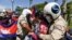 FILE - Local security personnel guards confiscate a loudspeaker from a protester during a protest to mark the 29th annniversary of the Paris Peace Accord in front of the US embassy in Phnom Penh on October 23, 2020. (AFP)