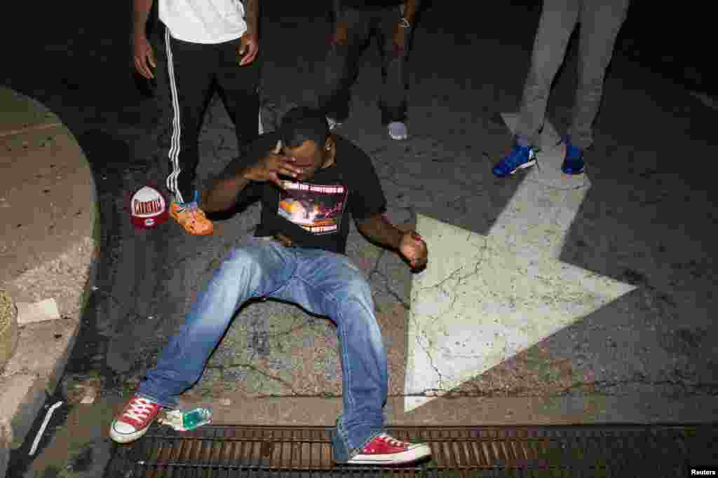 Protesters react to the effects of tear gas in Ferguson, Missouri, Aug. 17, 2014.