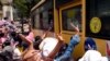 A crowd greets people aboard a bus as it leaves Insein Prison, in Yangon, Myanmar, April 17, 2021.