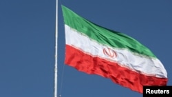 (FILE) The Iranian flag is seen flying over a street in Tehran, Iran, February 3, 2023.